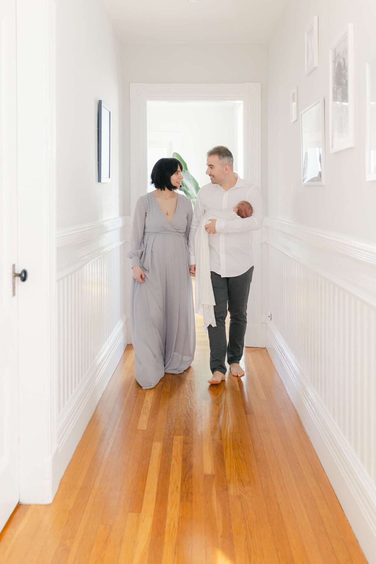 Cozy living room Bay Area newborn photography session with baby wrapped in a blanket.