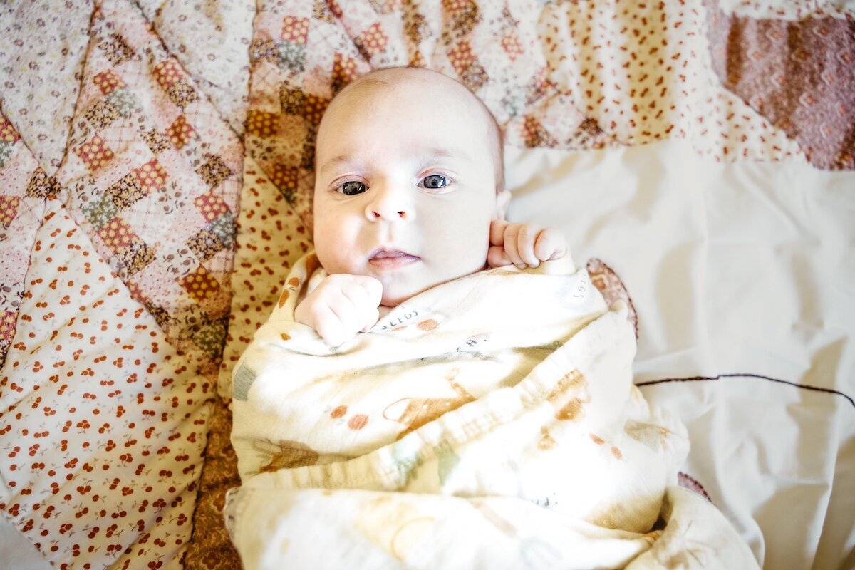 a newborn baby girl wrapped in a blanket