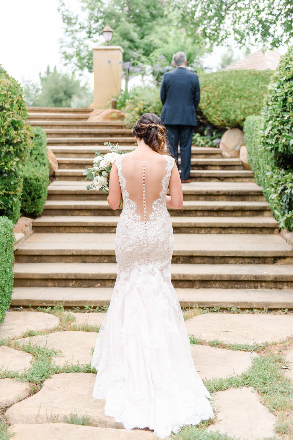 a bride and groom on long staircase