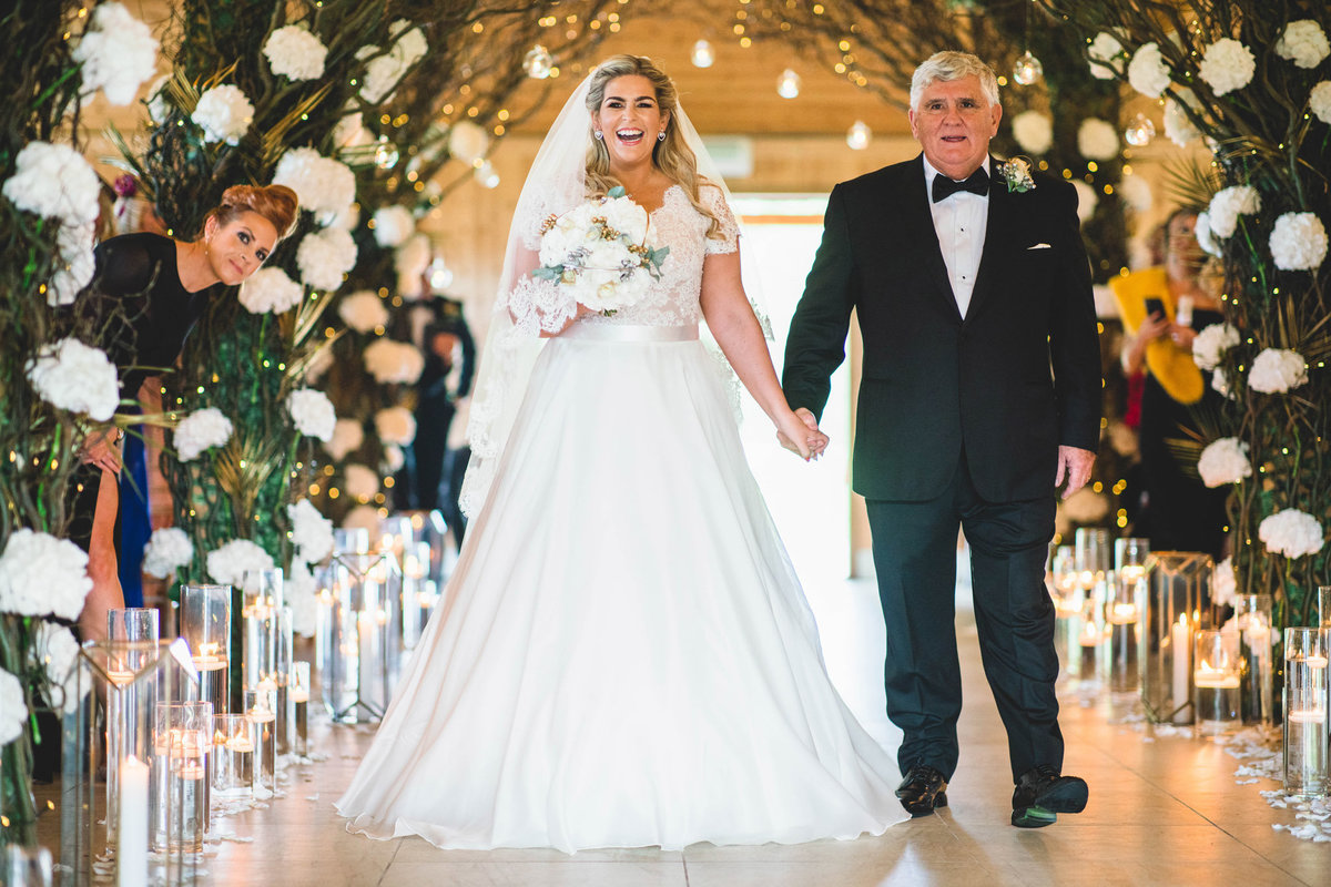 bride and her father walking down the aisle at merrydale manor