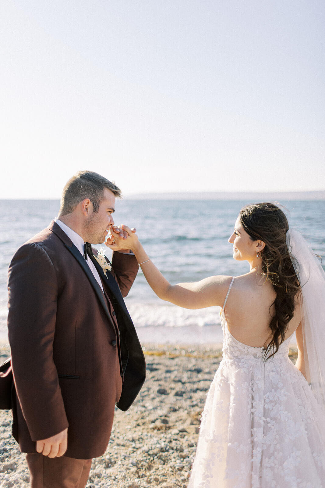 groom-kisses-brides-hand