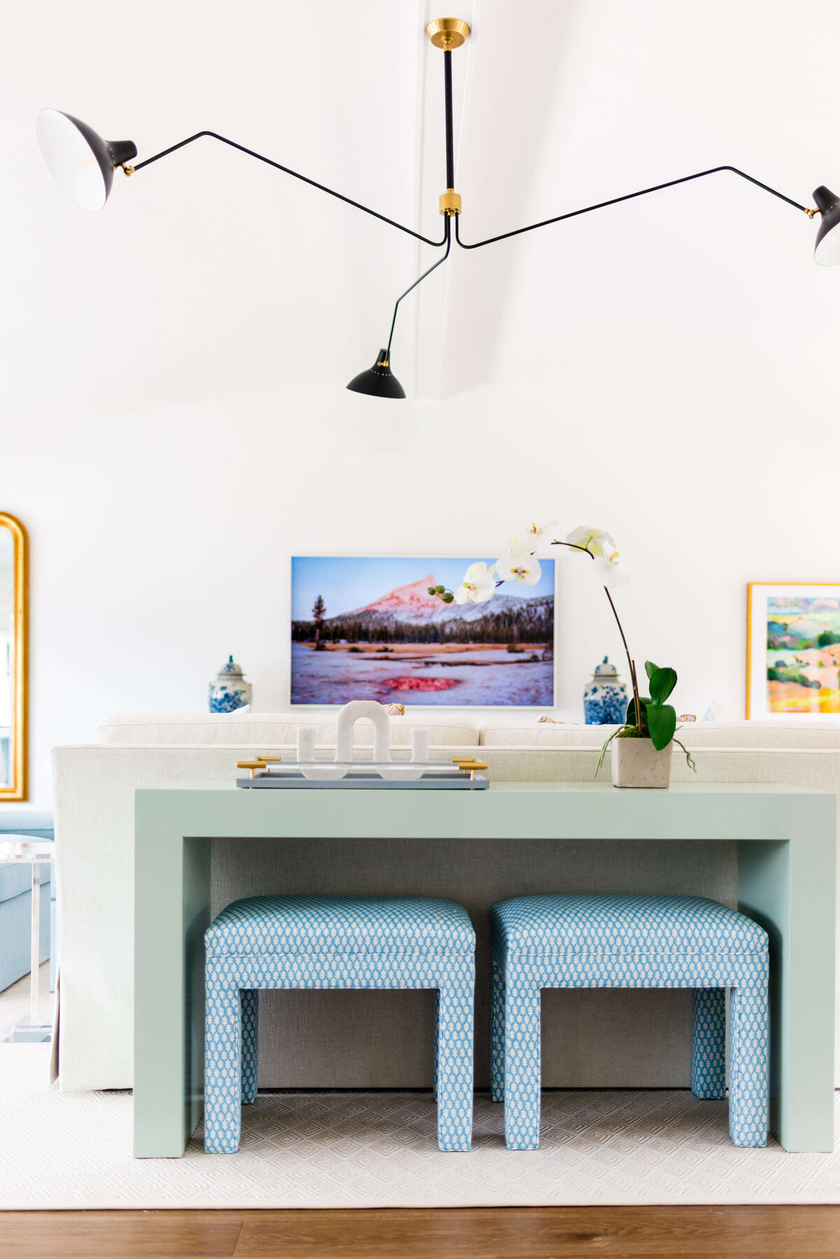 oyster creek studios building belt new build green side table with blue stools in living room