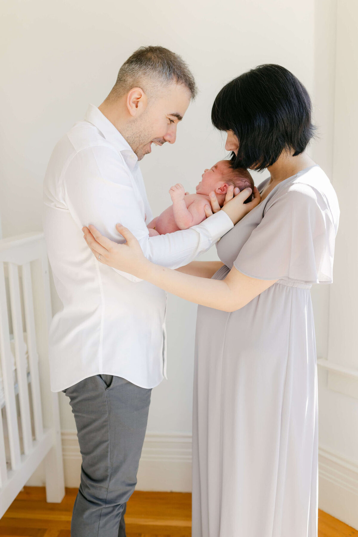 Cozy living room Bay Area newborn photography session with baby wrapped in a blanket.
