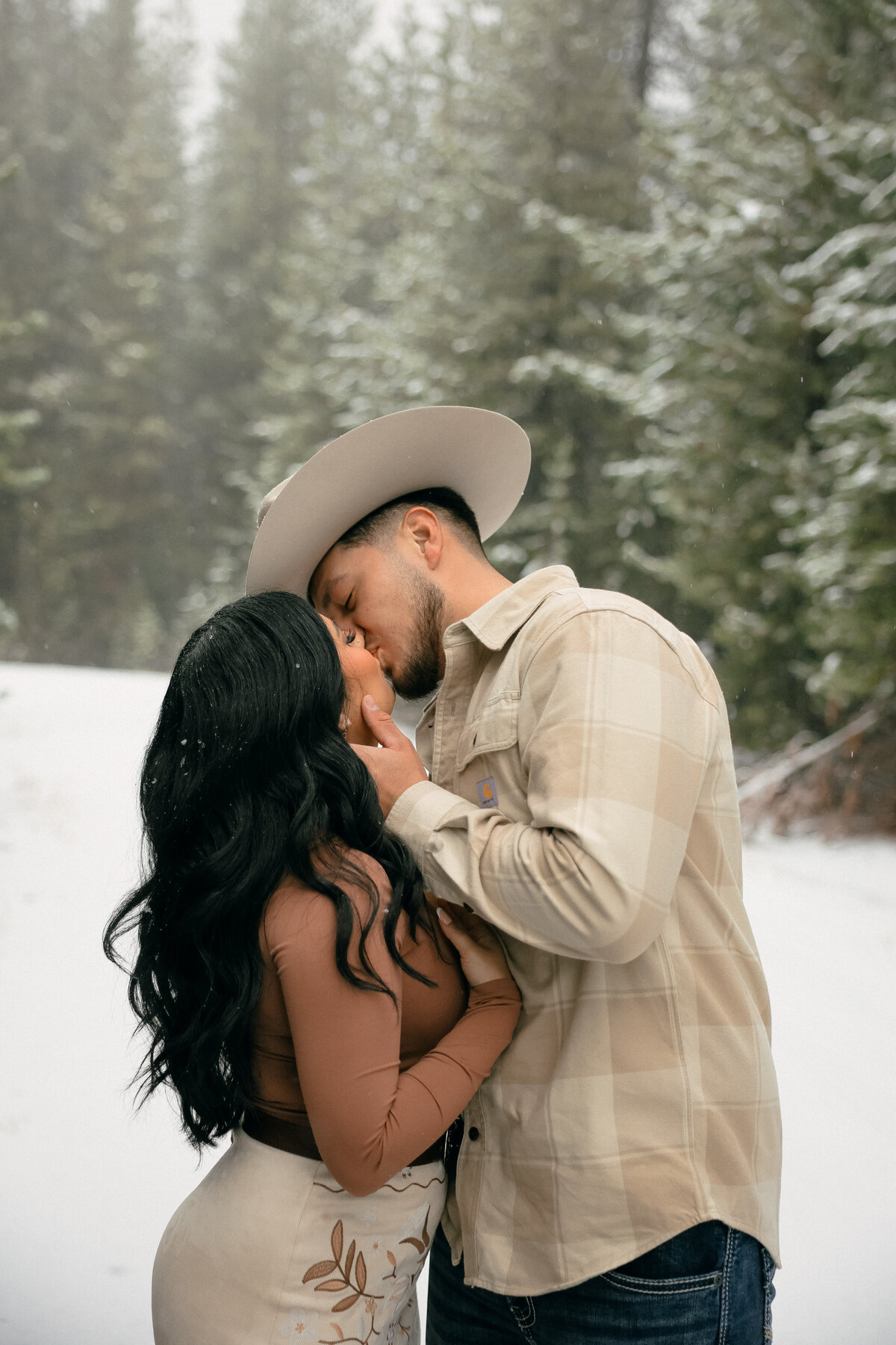 Western Engagement Session Kissing in the Snowy Oregon Forest