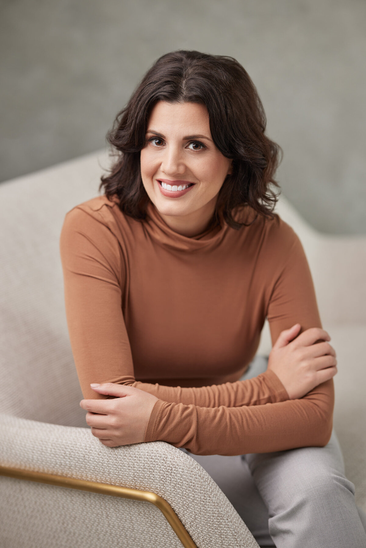 A woman sitting on a couch smiling