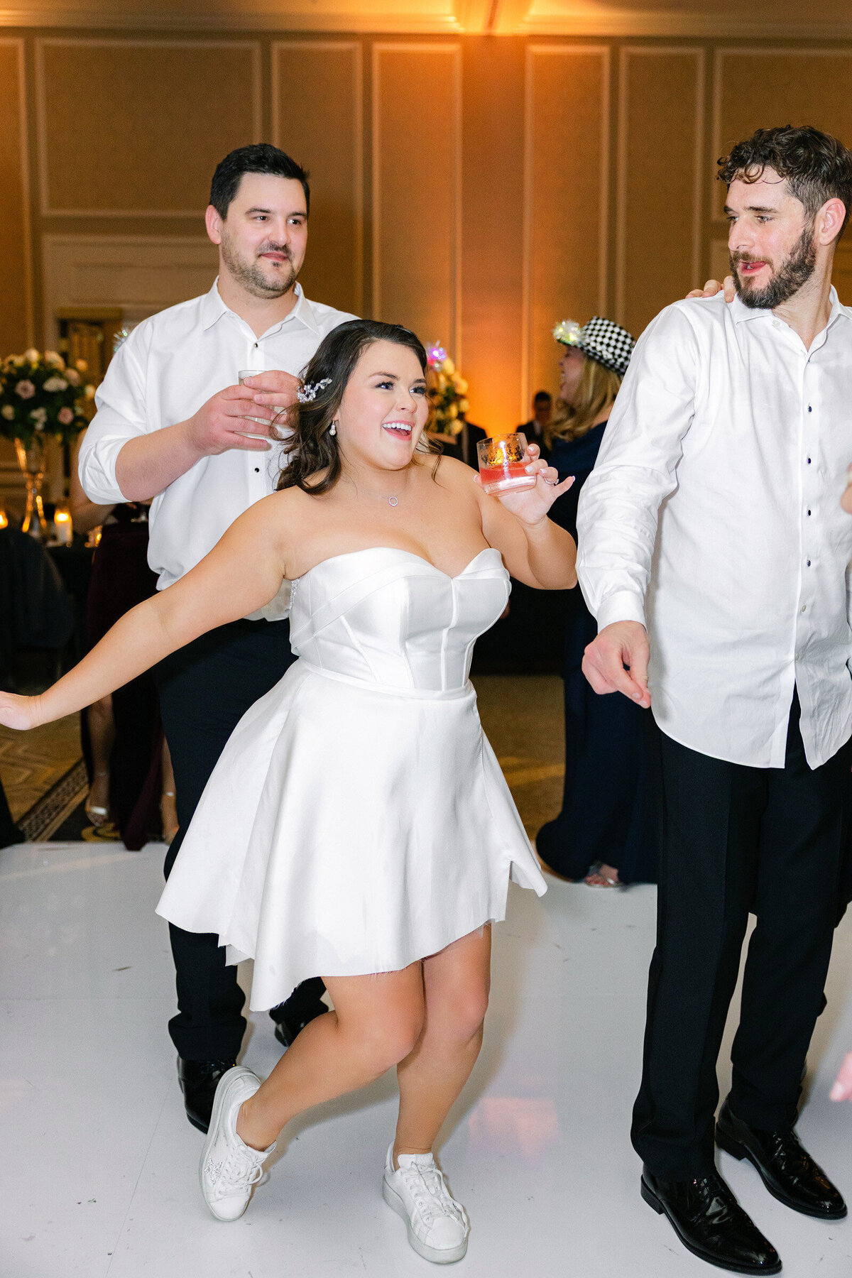 candid photo of a bride dancing at her wedding  at The Adolphus in Dallas