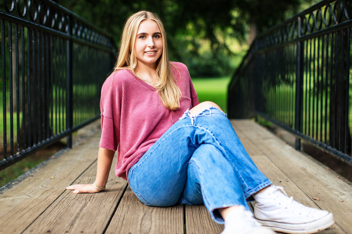 Creative senior photo Pittsburgh sessions of girl posing at schenley Park on a bridge.