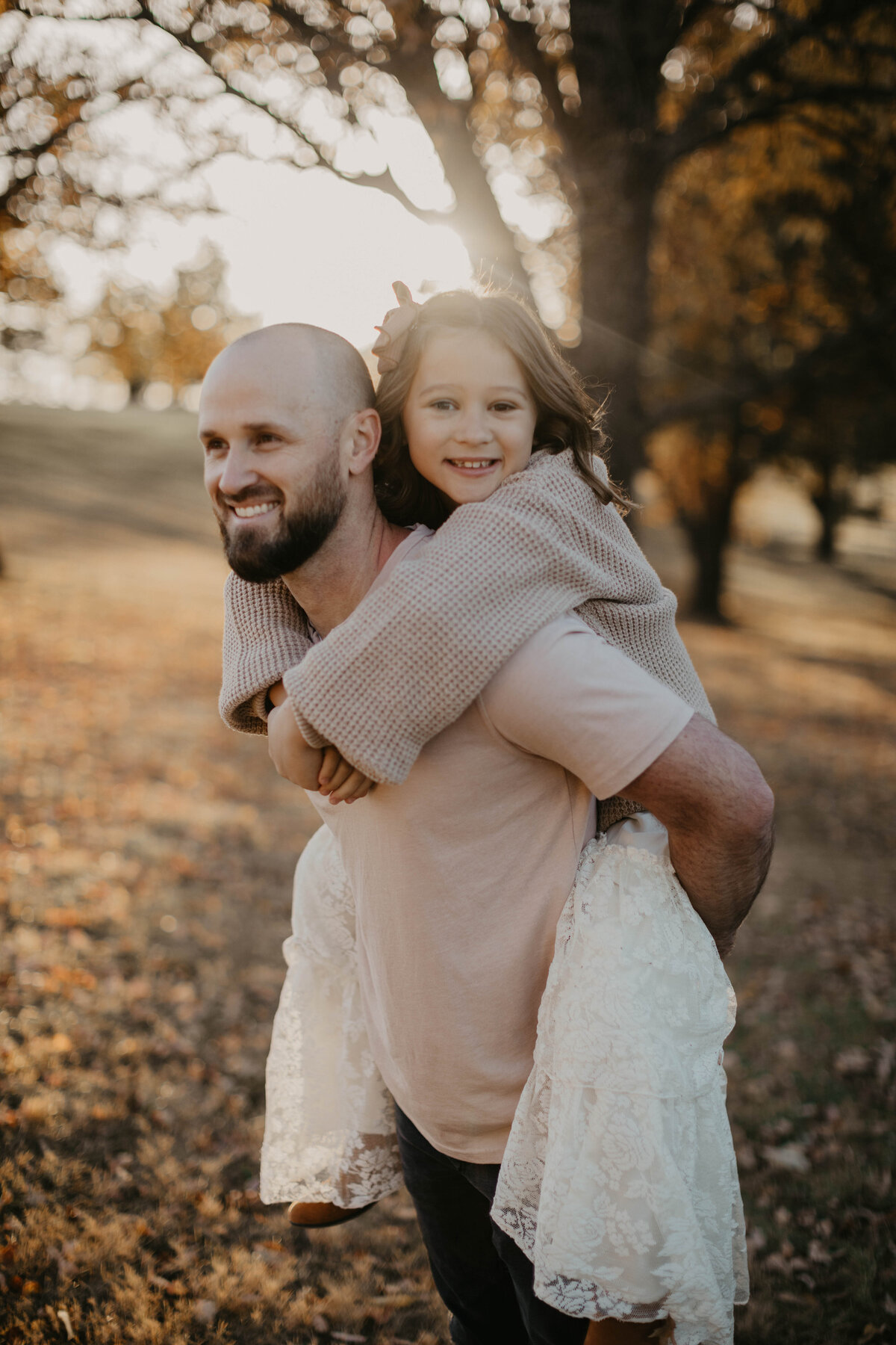 Daughter doing a piggy back ride on dad.