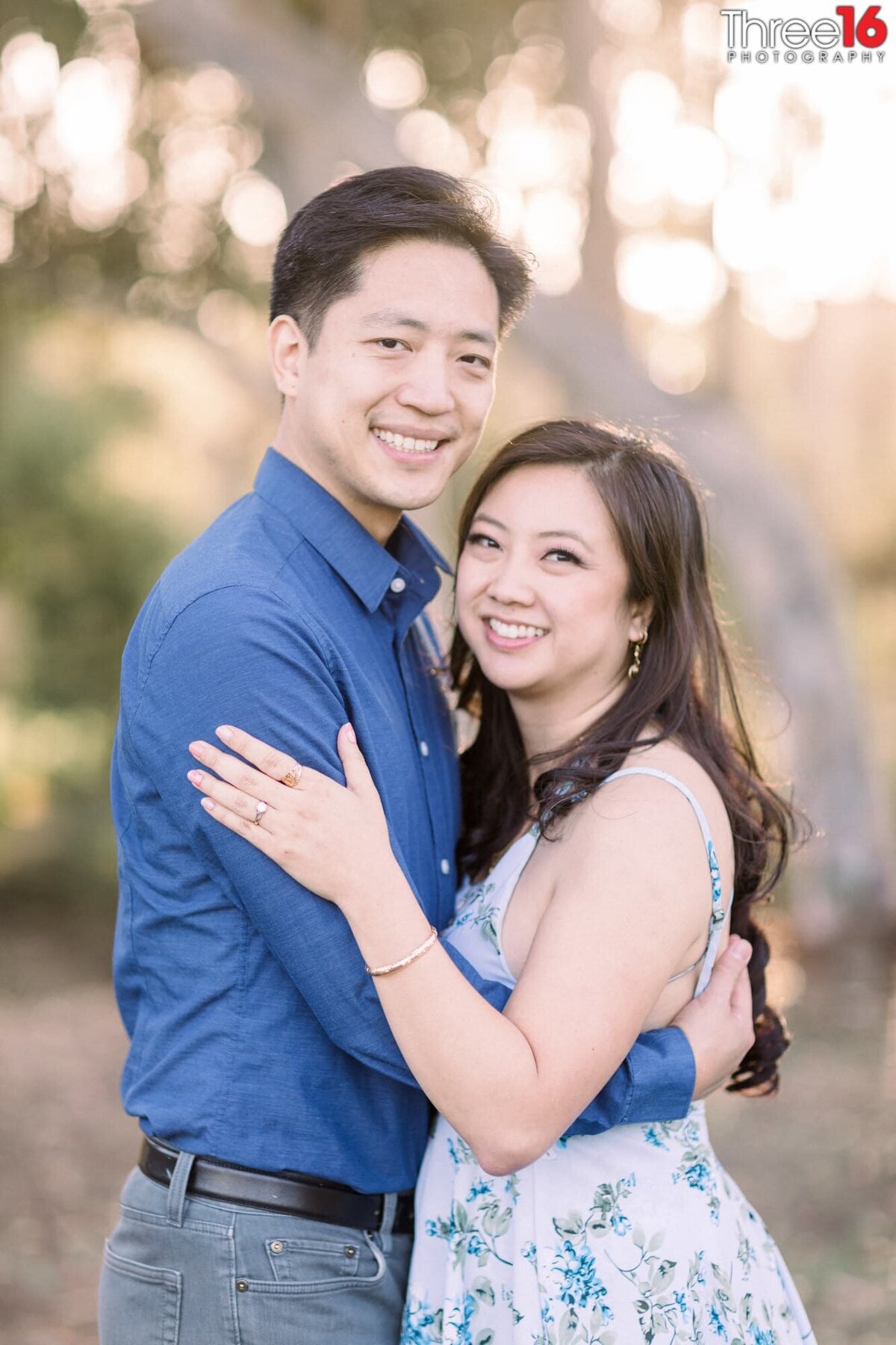 Engaged couple embrace one another during photo shoot