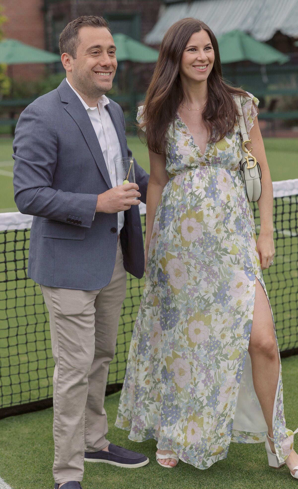 Guests mingle on the lawn of the Tennis Hall of Fame during a welcome party. 