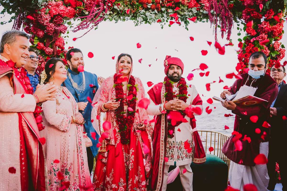 roses thrown over indian bride and groom during the hindu wedding ceremony at the piermont long island