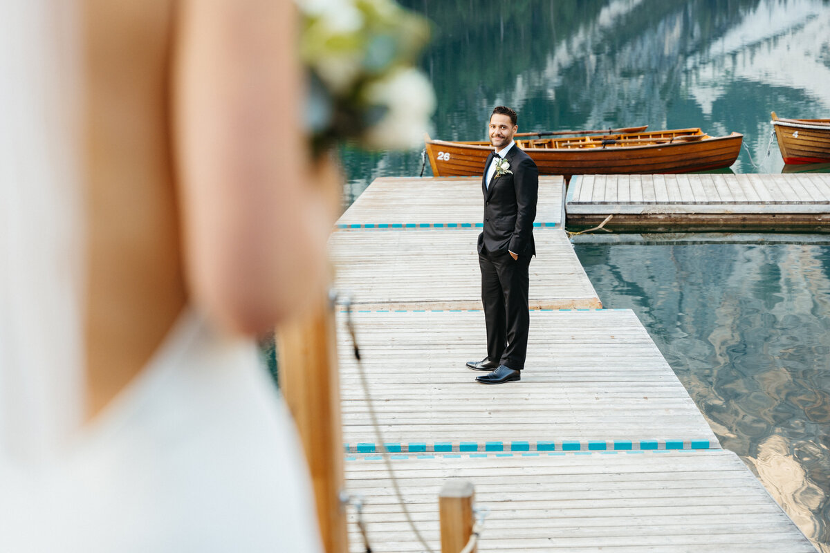 Groom waiting on dock at Lago di Braies