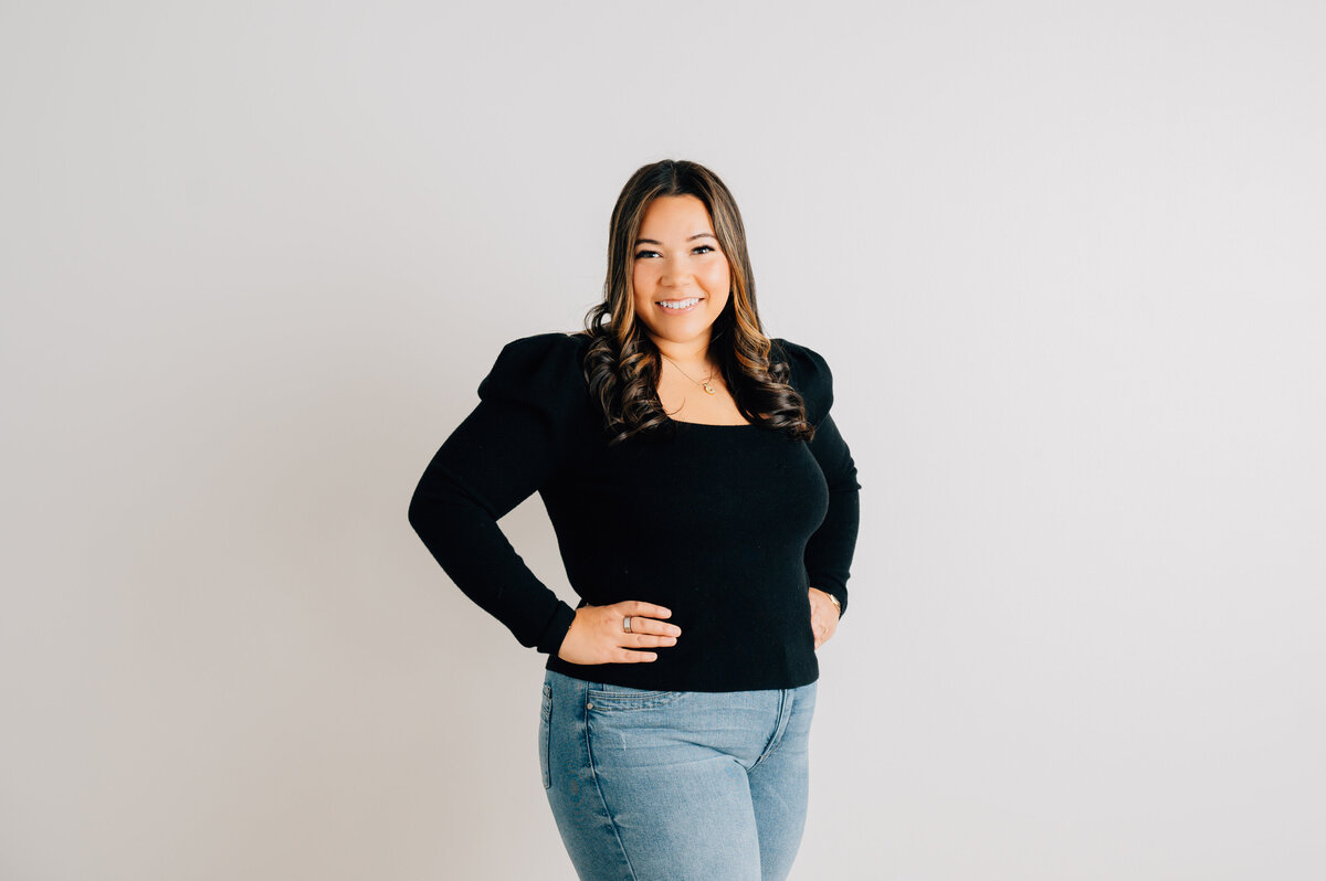 Smiling woman headshot by Lissette G in minimal white studio for Houston clients