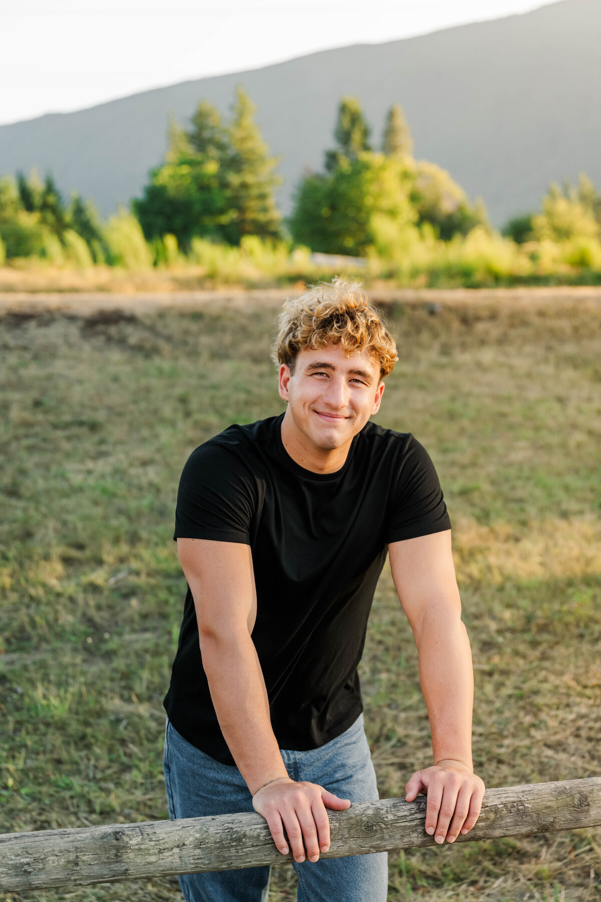 guy leaning on fence park senior