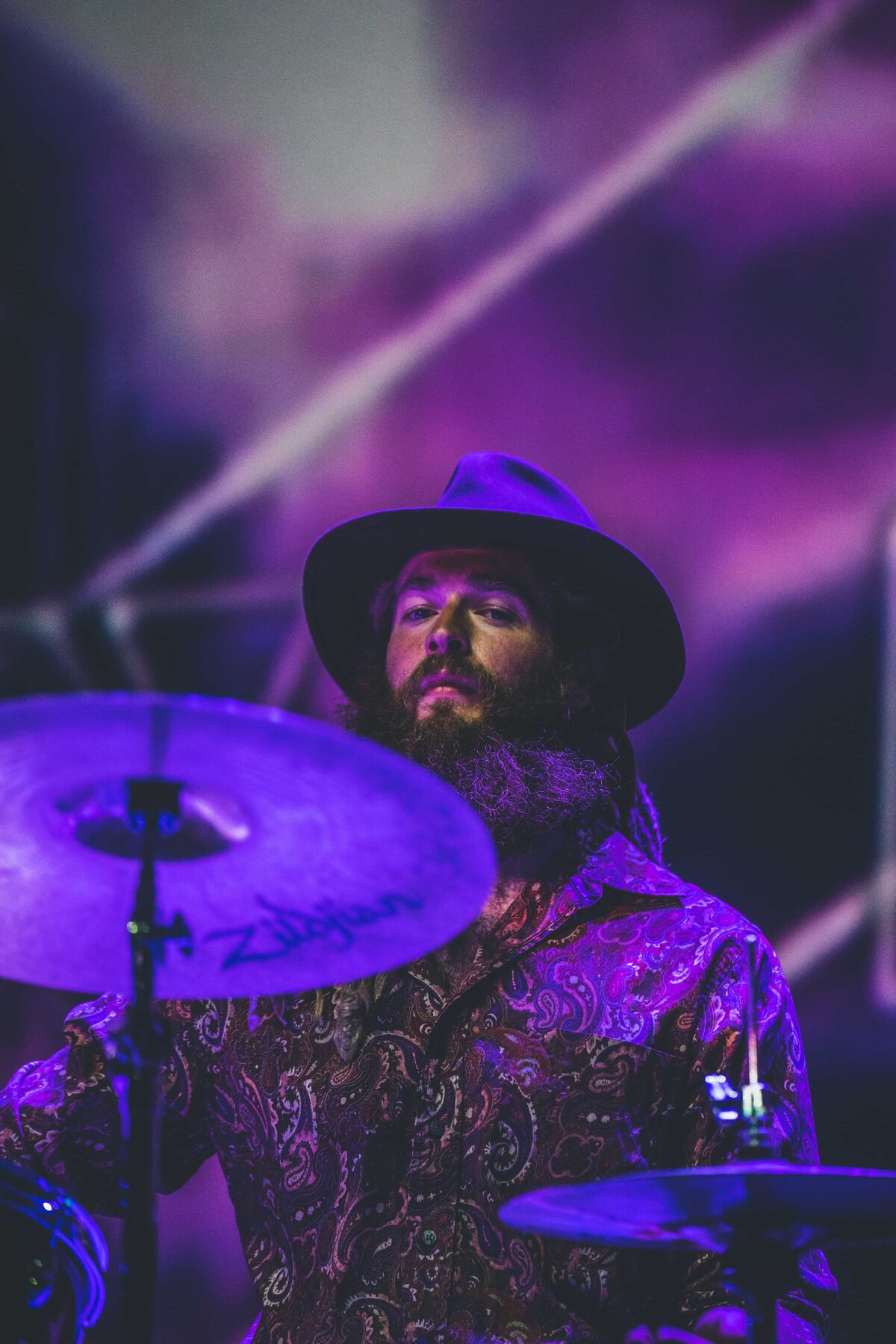 drummer with purple background performing