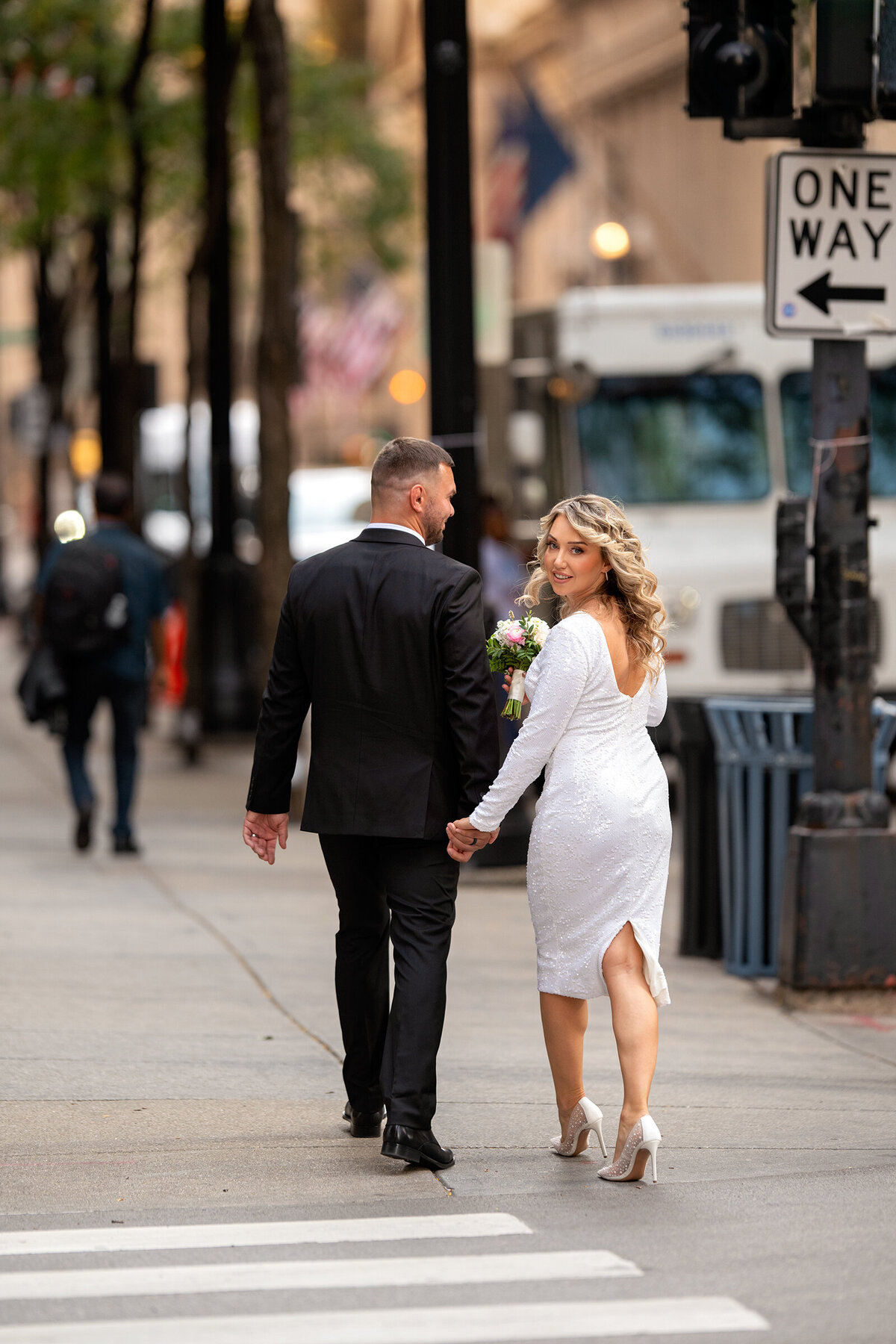 Documentary style picture of groom and bride crossing busy Chicago street