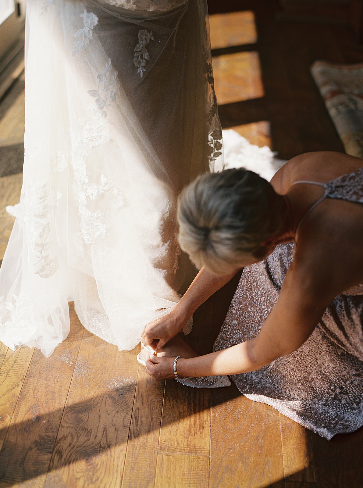 a woman making adjustments to a wedding dress