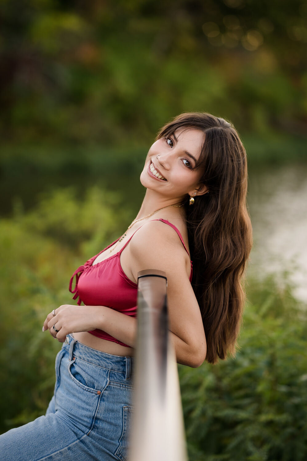 GIRL LEANING ON POLE AND SMILING