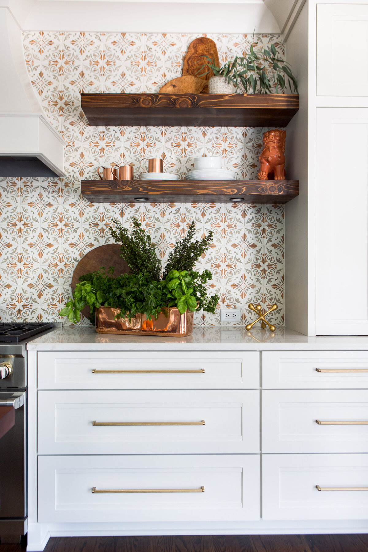 Stylish kitchen in Lake Norman, NC, featuring open shelves with warm wood tones and greenery.