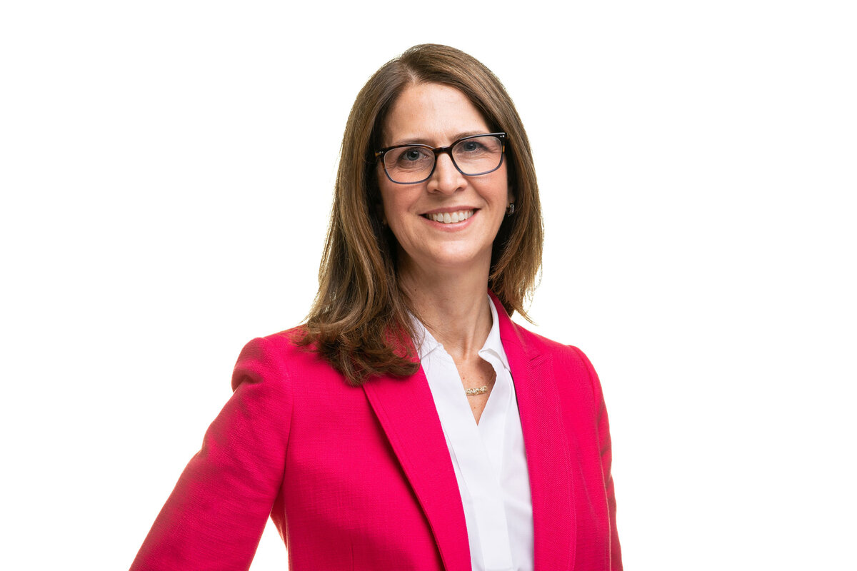 Women in pink poses for a professional headshot