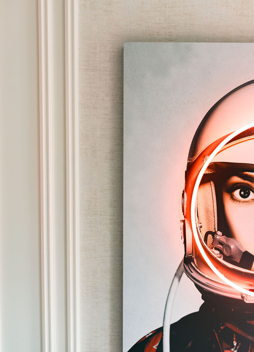 Close up look at a portrait of a female astronaut with a white helmet illuminated by pink LED,.\