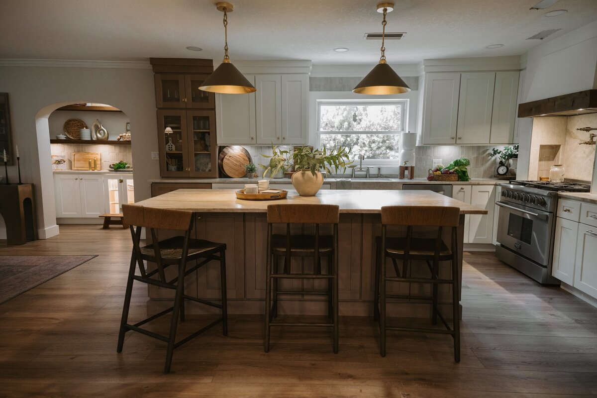 dewine design interiors vintage cove trail kitchen with wooden flooring white cabinets with gold pendents