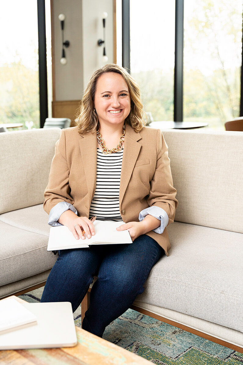 social media manager sitting on the couch in columbia MD hotel lobby for a personal branding photoshoot