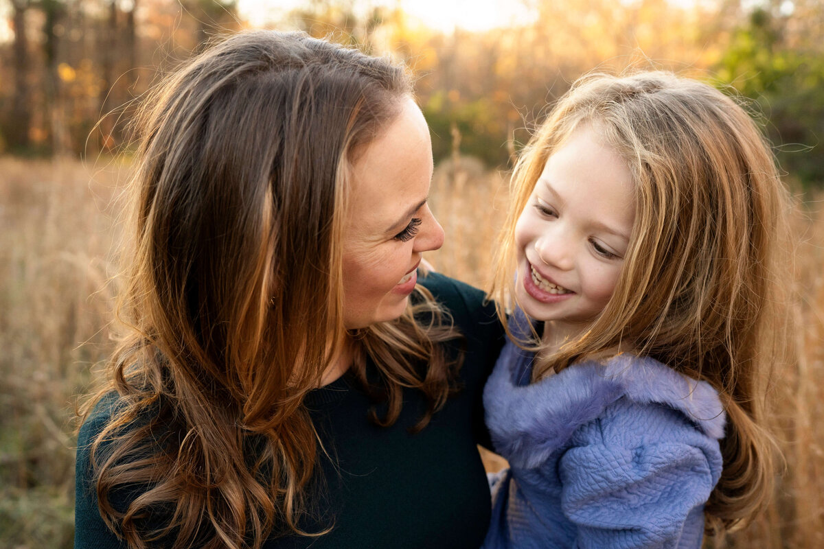Mother and daughter smiling at each other during family photography session in Atlanta