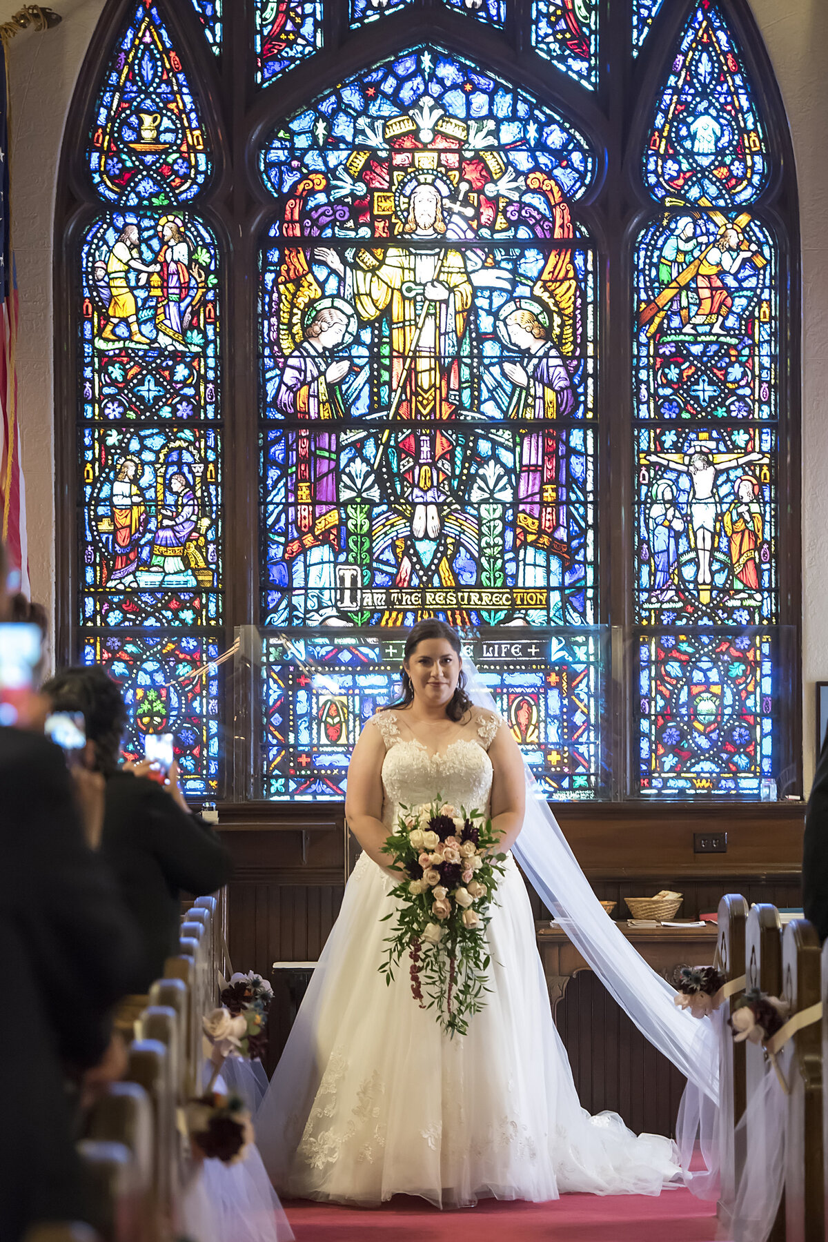 A person in a wedding dress walking down an aisle 