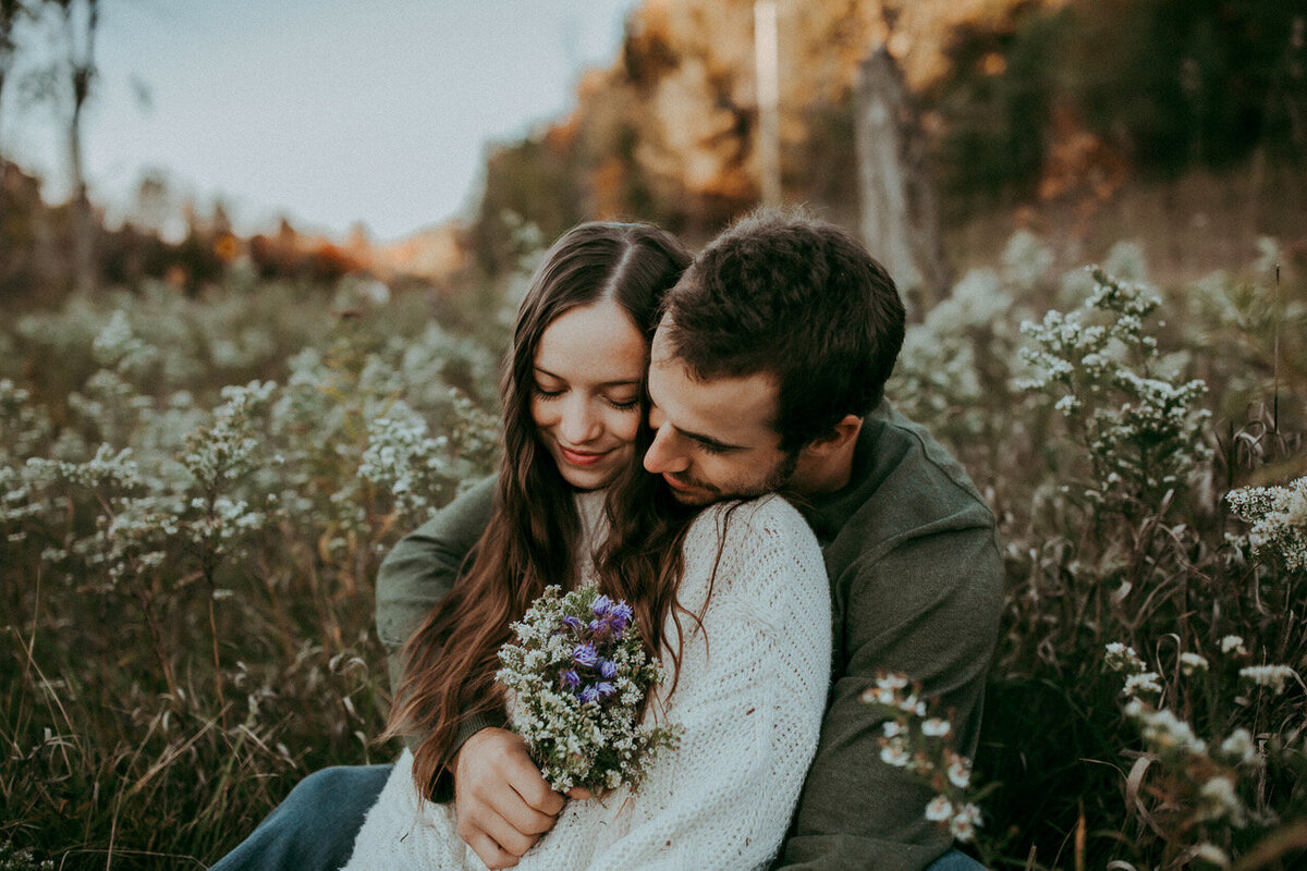 Engaged couple holding each other during their session in Kitchener, Ontario.