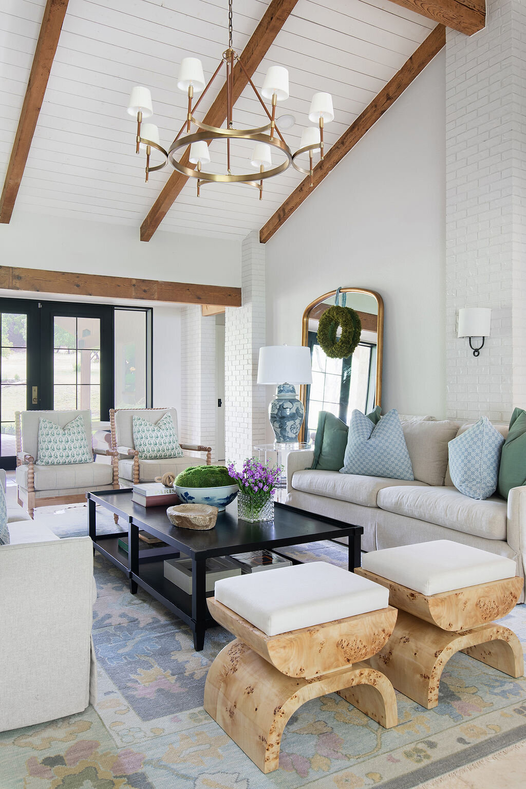 living room with high ceilings that have exposed wood beams