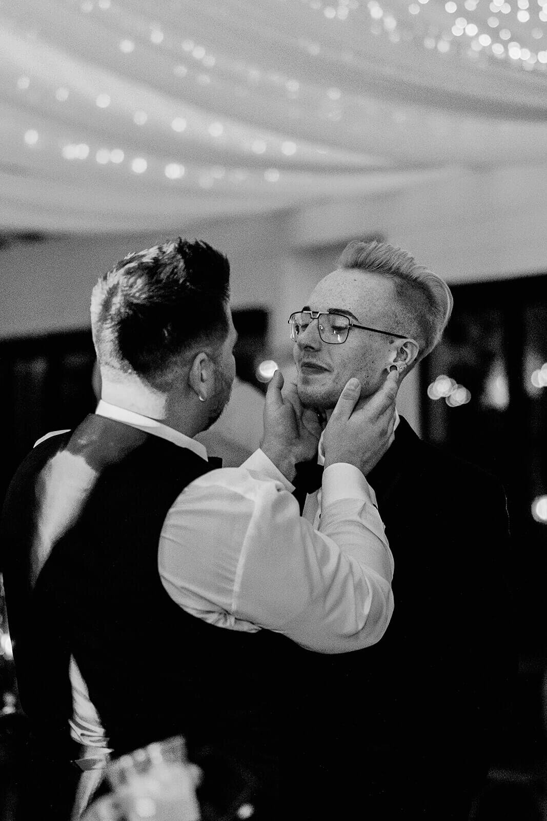 two grooms dancing at wedding reception