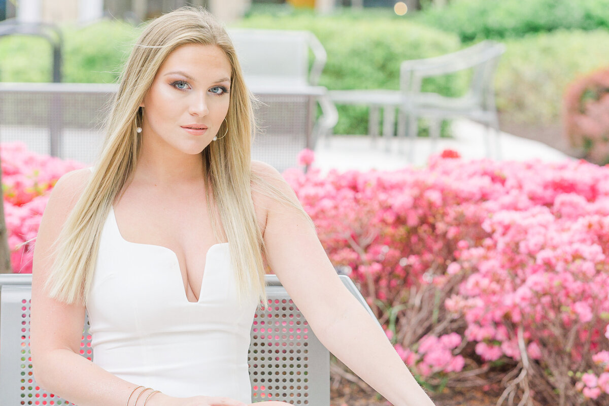 girl sitting by the flowers during Leesburg, Virginia senior pictures