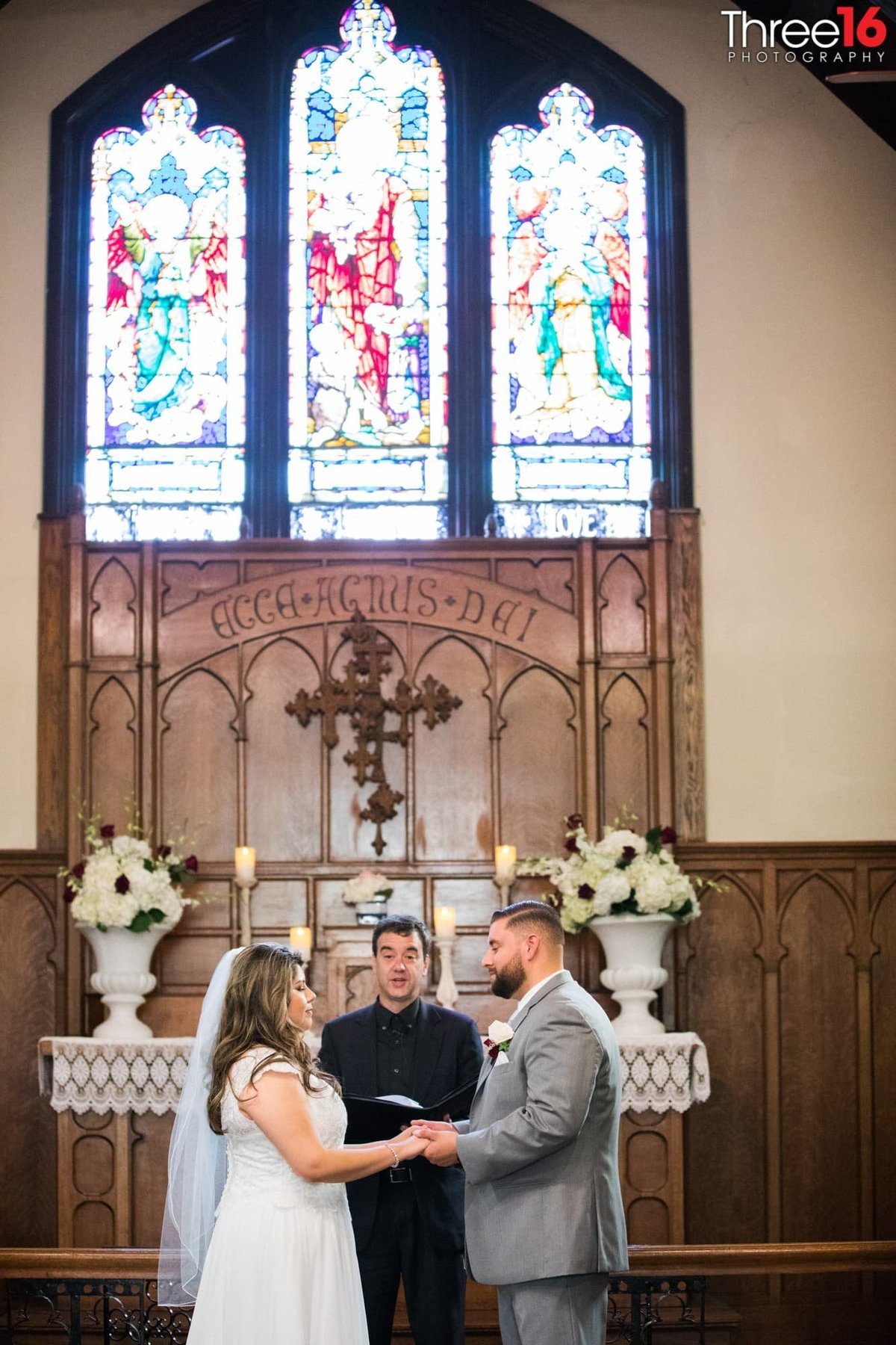Officiant performing the ceremony as Bride and Groom stare at each other