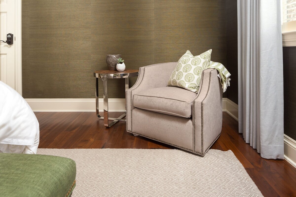 the keeping room interiors grandview bedroom corner chair with round side table and dark wood floors
