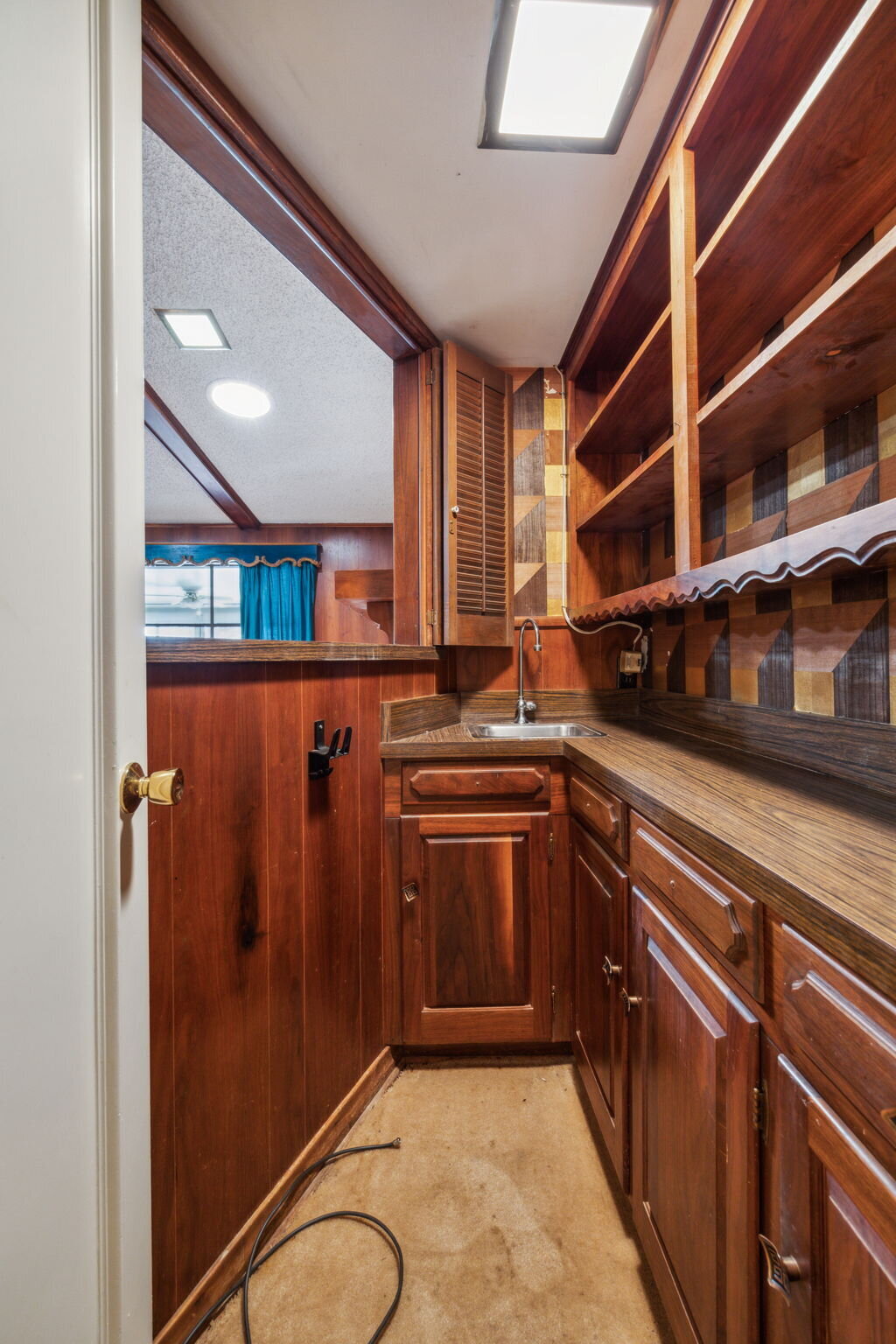 14214_edgecrest_dr_dallas_tx_home_bar_area_-vintage_wet_bar_with_wood_cabinetry_and_open_shelving-_haven_realty_group