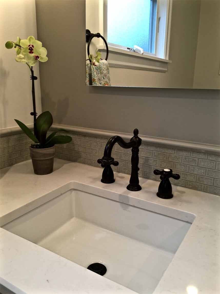Bathroom with white sink and grey wall