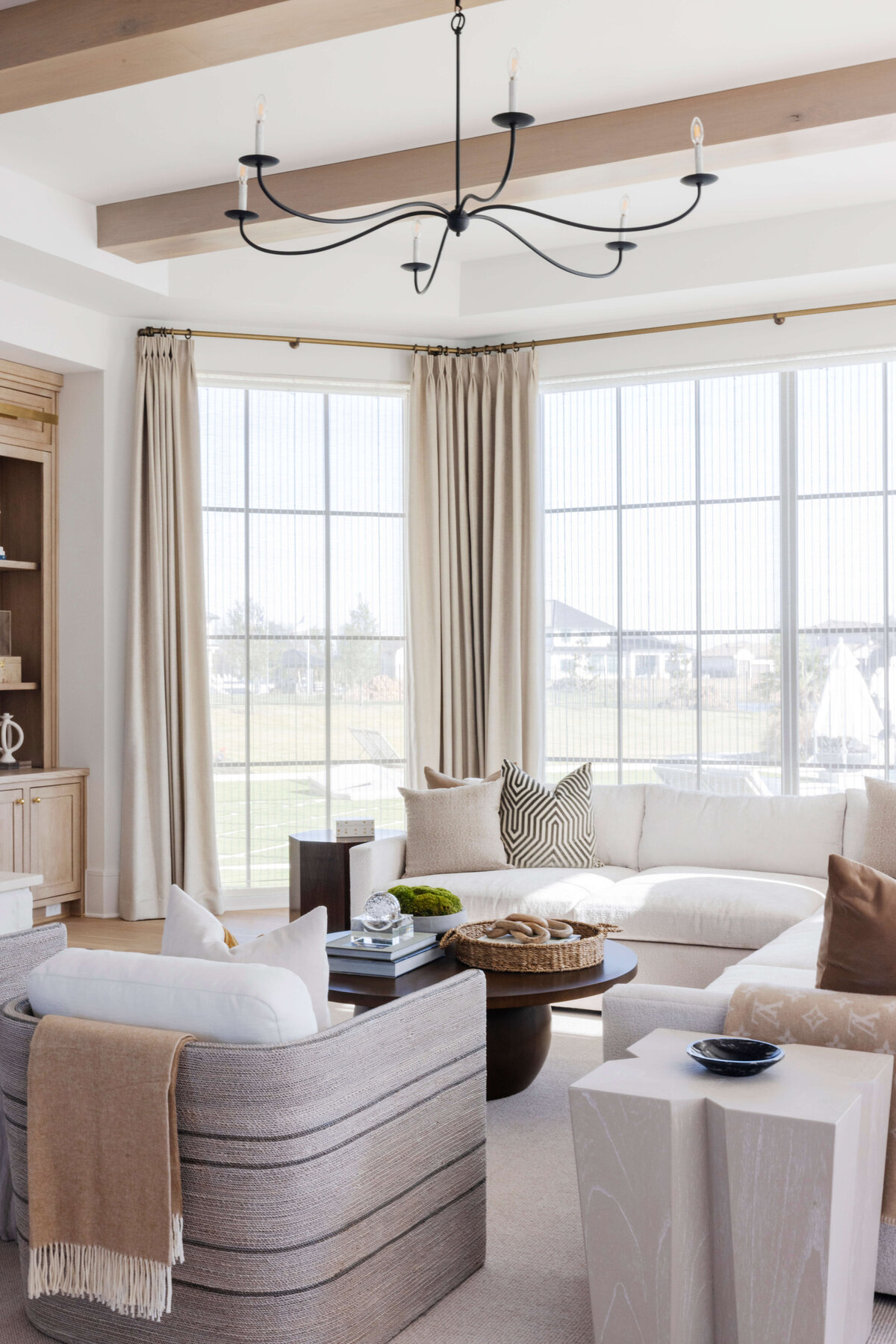 oyster creek studios hughes white sofa and dark wooden coffee table and wicker basket in living room