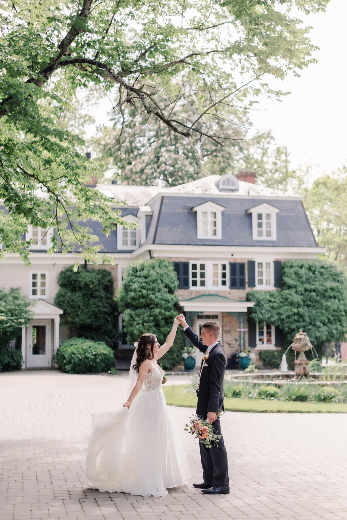 Editorial wedding portrait outdoors, a bride and groom sharing their first look together in front of their chateau inspired wedding venue