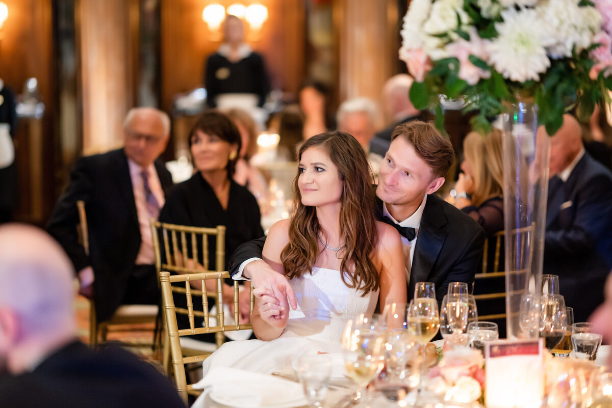 bride and groom intently listening to wedding toasts inside of the ballroom at the duquesne club