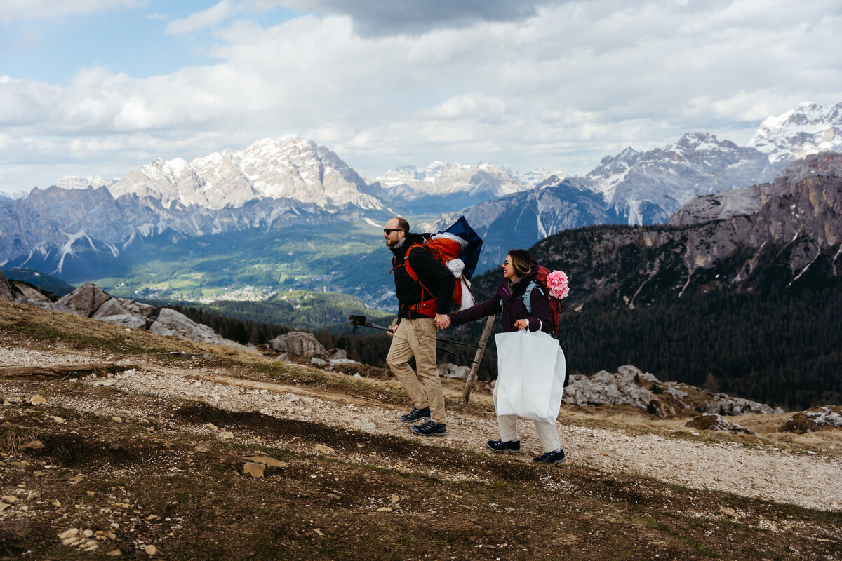 Adventurous couple celebrating on hiking trail in Dolomites