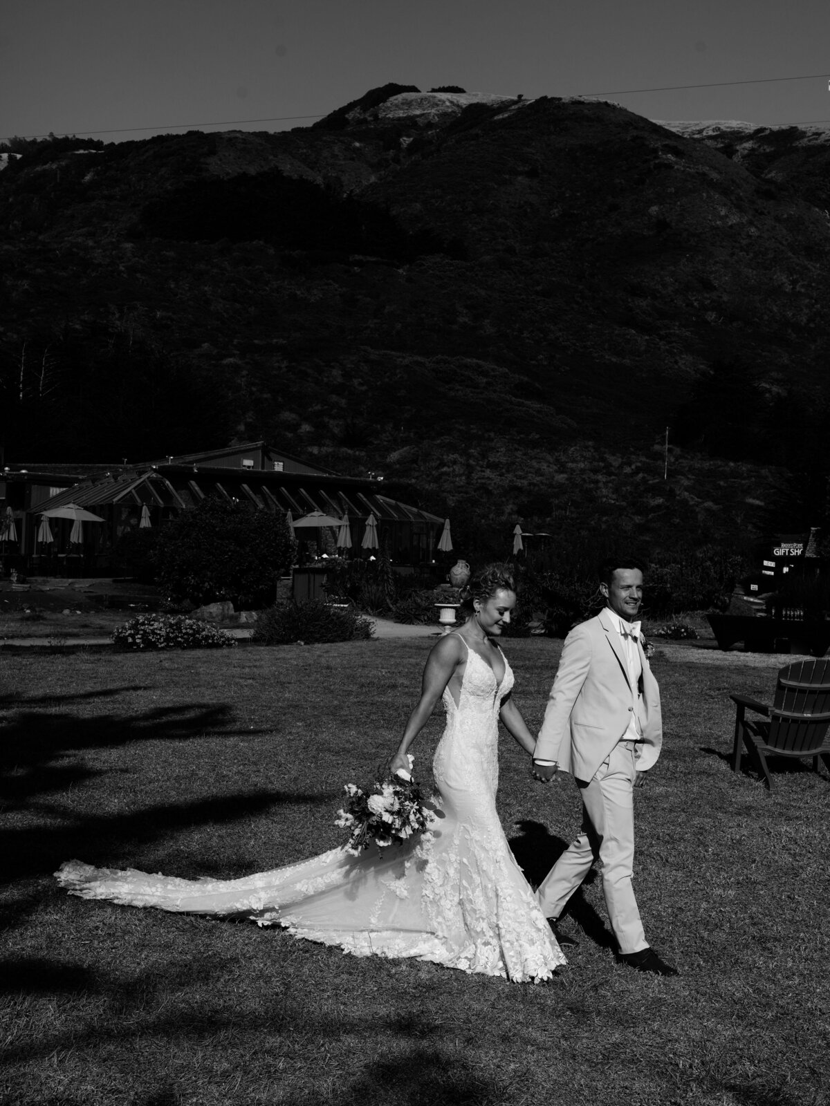 Bride and groom walking along holding hands