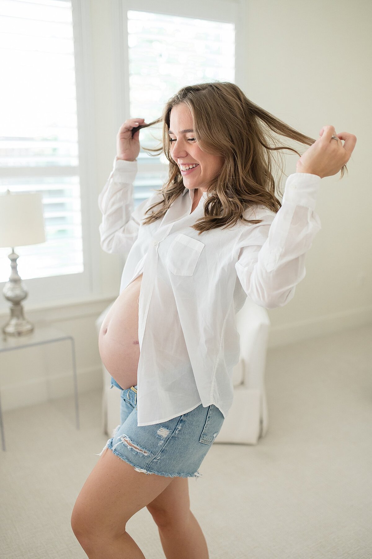 Mama posing during a fun loving studio maternity photoshoot