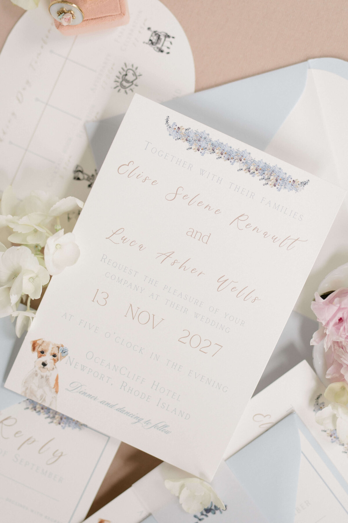 Custom coastal wedding invitation suite with delicate florals, classic typography, and a watercolor dog illustration by White Heart Design.