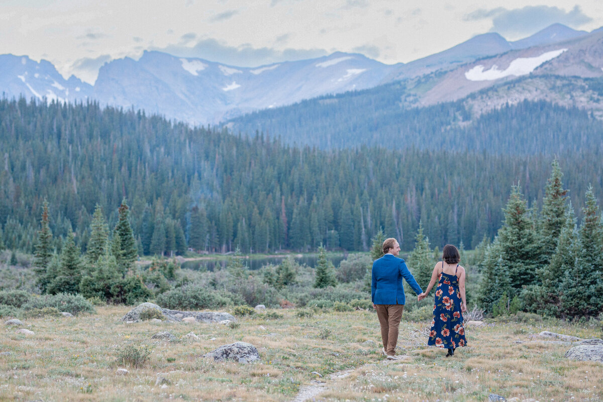 An engaged couple walk together toward Brainard Lake, photo by Boulder Engagement Photographer Stephanie Eddy