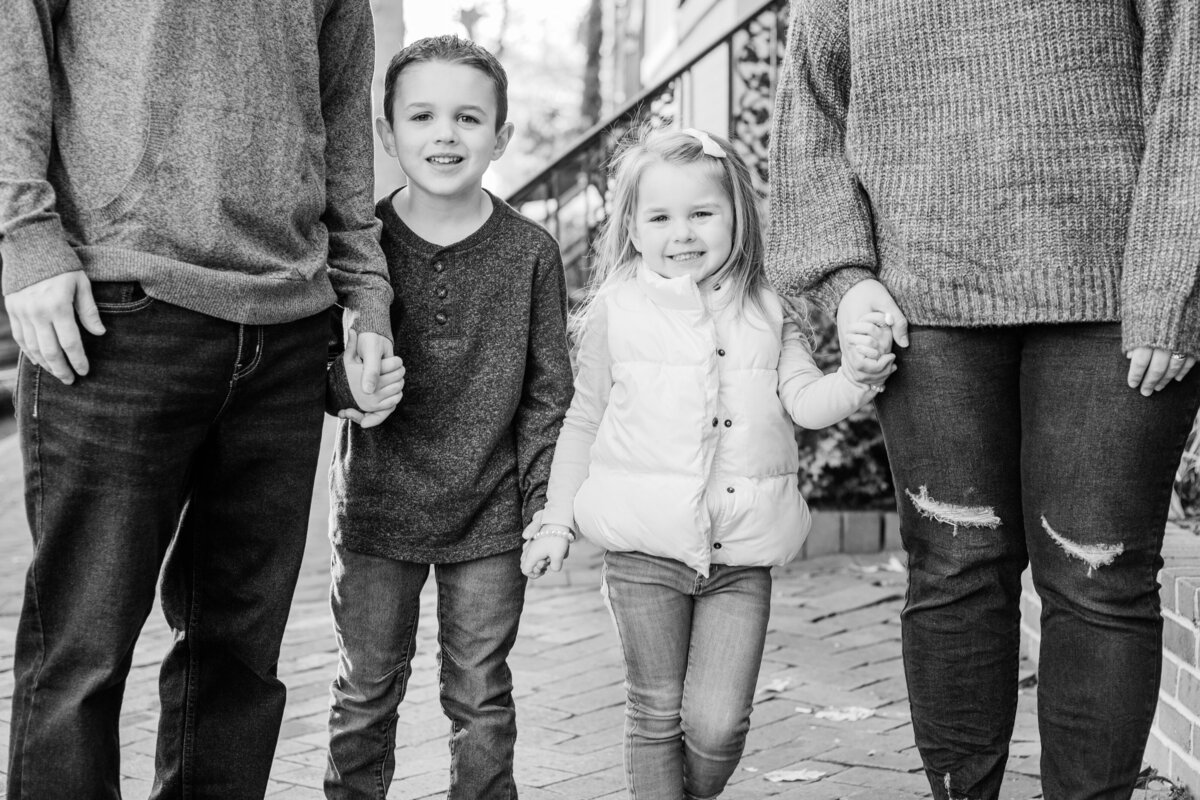 Black and White image of family holding hands