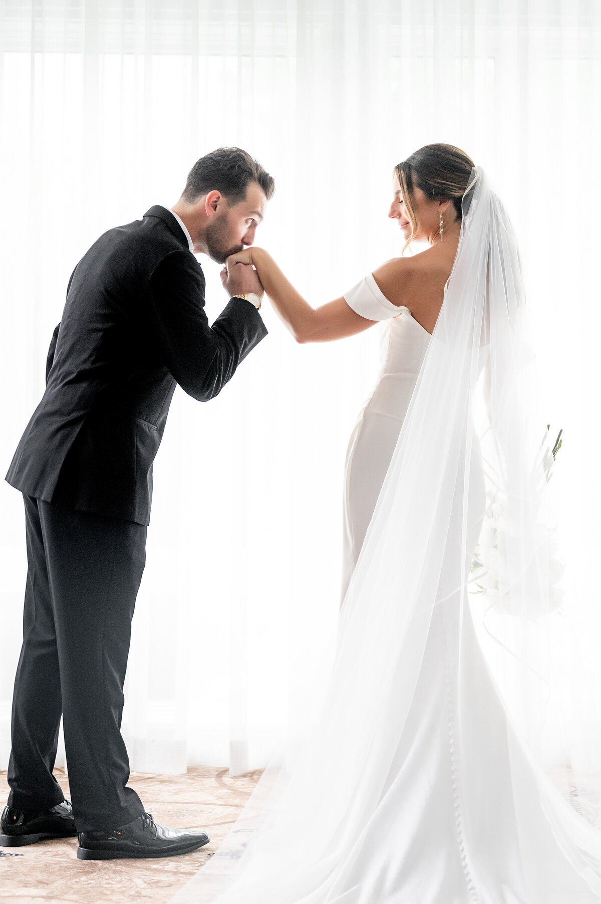 groom kissing brides hand in creative pittsburgh wedding photo