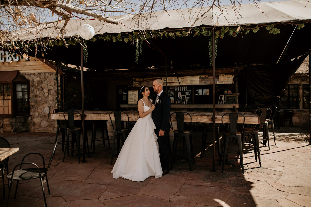 bride and groom standing together at a brewery in Santa Fe