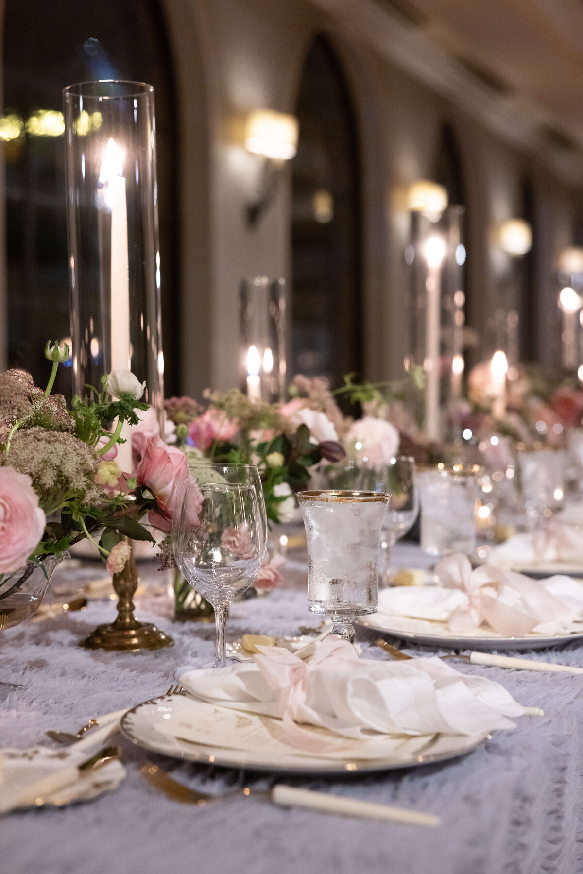 Candlelit wedding reception with blush and white flowers