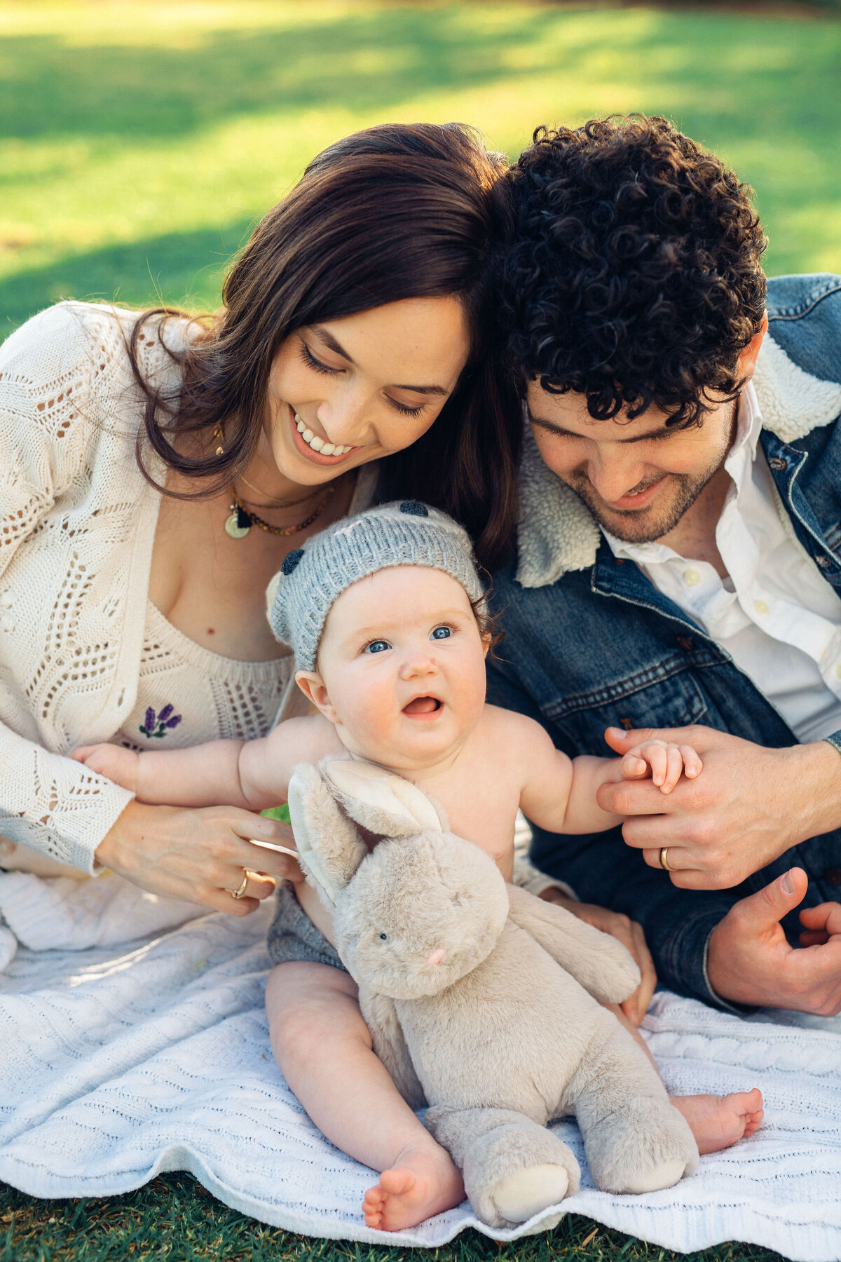 Family Portrait Photo Of Couple Smiling While Holding Their Baby In Topless Los Angeles